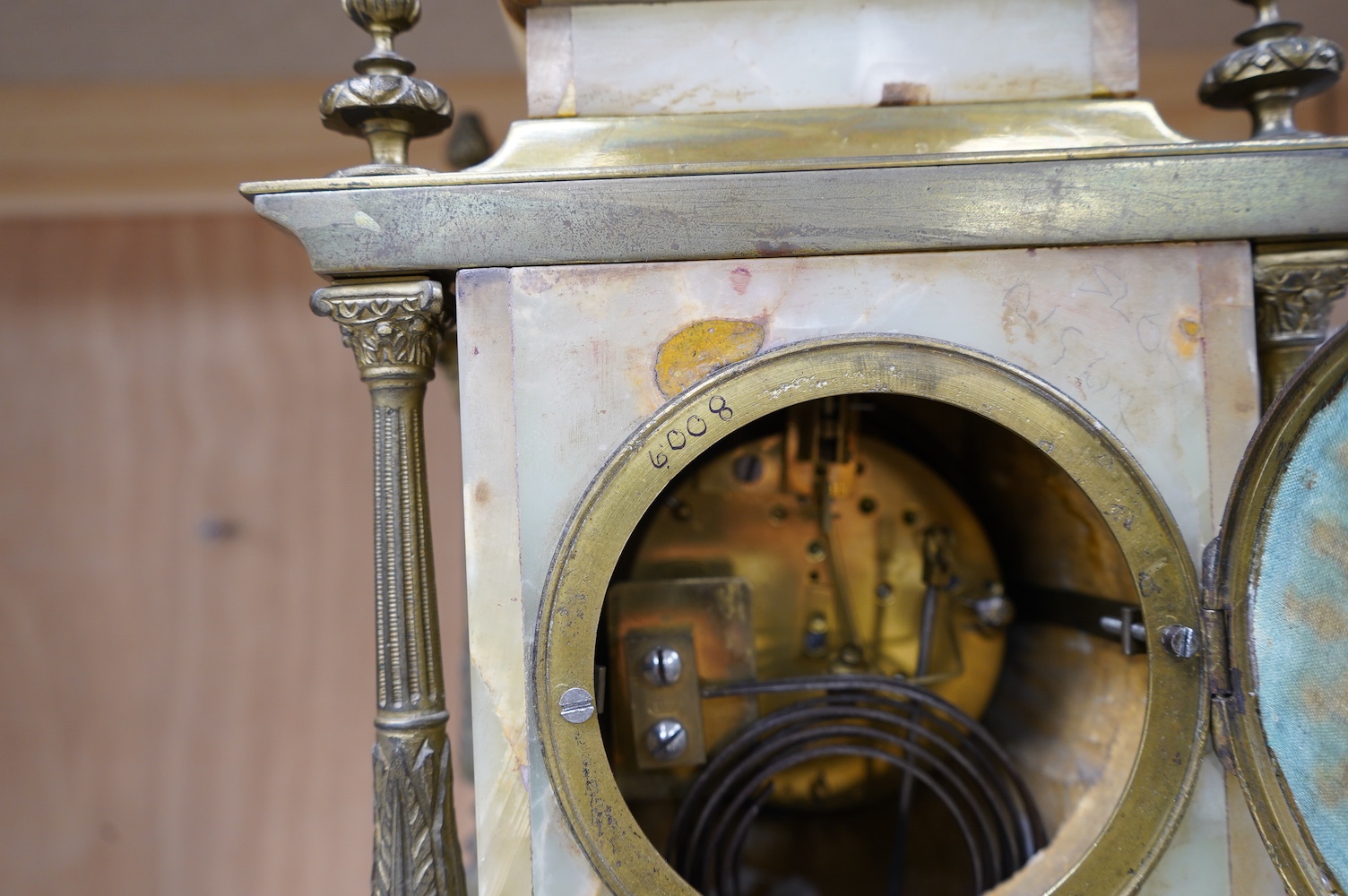 An early 20th century marble and onyx mantel clock with enamel dial with pendulum, no key, 32cm high. Condition - fair, untested